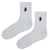 Cat Patch White Socks. Designed with a clean white base and a subtle embroidered black cat wearing sunglasses,