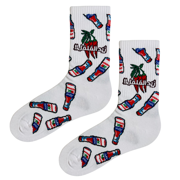 White crew socks with Cristal hot sauce bottle and chili pepper pattern and Arabic text
