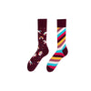 Magical Unicorn & Rainbow Striped Socks. One sock features playful unicorns, rainbows, and stars on a deep maroon background