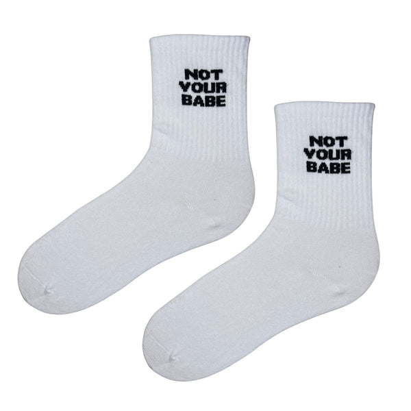 Not Your Babe Socks — bold, minimalist, and full of confidence. Made from soft Egyptian cotton for all-day comfort, these unisex white crew socks combine comfort with attitude.