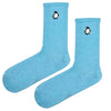 Penguin Embroidered Sky Blue Socks. These cozy unisex socks feature a cute black and white penguin icon stitched near the cuff