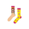 Pop Art Kiss Socks – featuring vibrant comic-style artwork and bubblegum kisses! One sock showcases a retro pop-art woman in sunglasses, while the other bursts with pink lips and gum graphics on a bright yellow base
