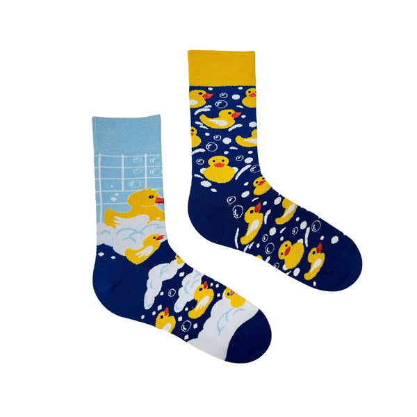 Rubber Duck Bath Socks feature an adorable bath scene with bubbles, tiles, and cute yellow ducks. The fun mismatched design (one light blue, one navy