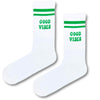 White crew socks with green stripes and 'GOOD VIBES' lettering