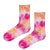 Sunset Tie-Dye Crew Socks. Designed with a vibrant blend of red, pink, orange, and white shades